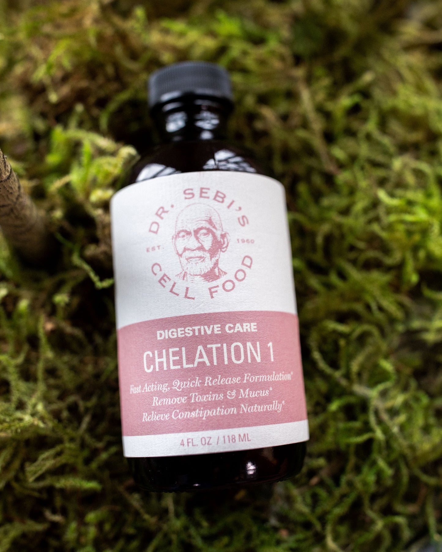 Dr. Sebi's Chelation 1 digestive care bottle on moss background for natural constipation relief.