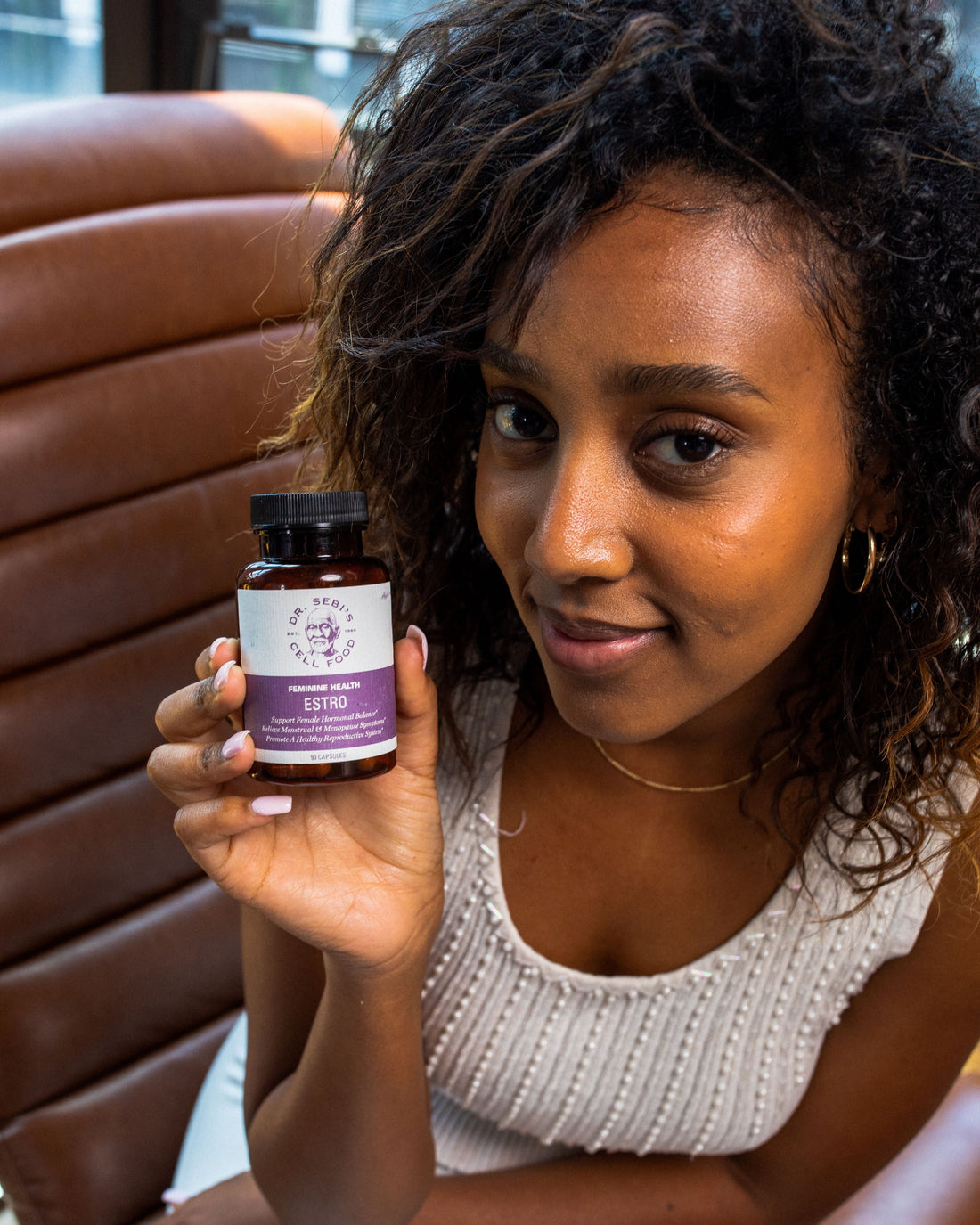 Woman embracing natural hormonal balance with Dr. Sebi Estro supplement