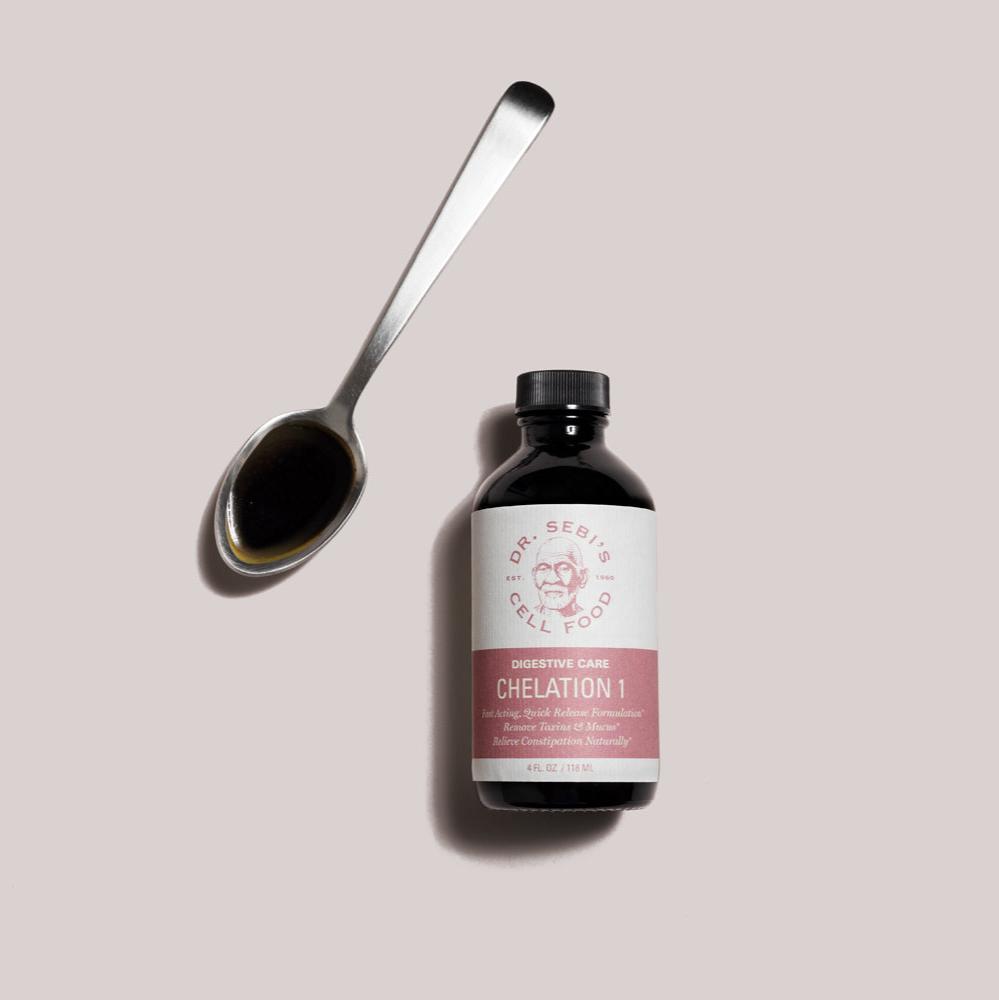 Dr. Sebi's Chelation 1 digestive care bottle next to a spoon filled with dark liquid on neutral background.