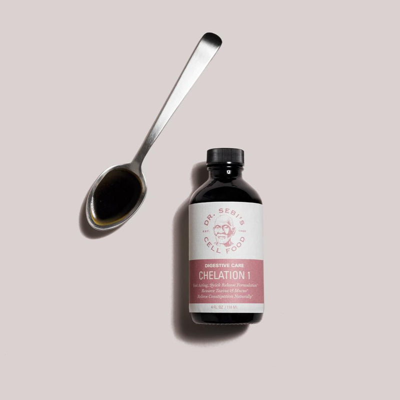 Dr. Sebi's Chelation 1 digestive care bottle next to a spoon filled with dark liquid on neutral background.